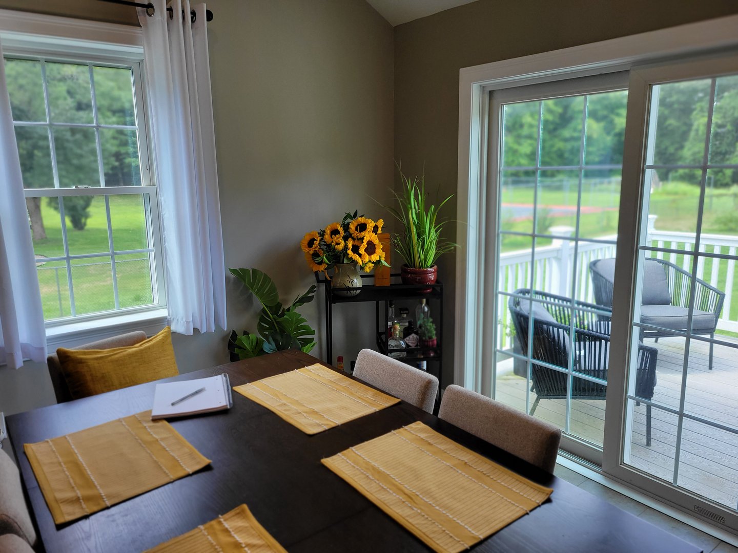 This photograph shows the author's dining room, which is again decorated cleanly and simply. A writing notebook sits askew on the table.